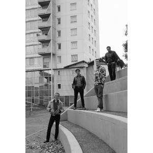 Quatre musiciens debout sur des gradins en pierre